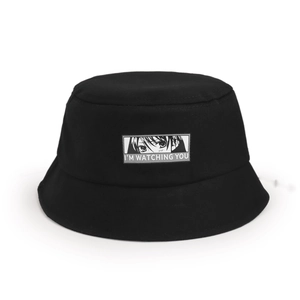 Detail of black cotton sun hat featuring a patch with eyes and I'M WATCHING YOU text