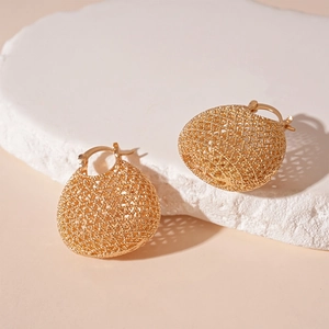 French style gold mesh hollow ball drop earrings on white stone tray for women