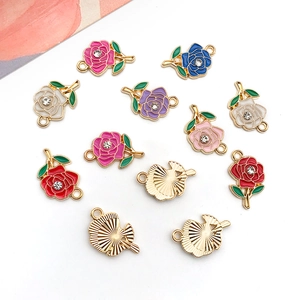 Detailed top view of colorful rose charms with rhinestones and gold alloy edging