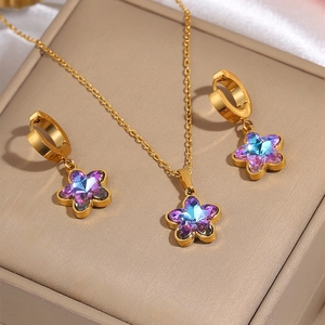Golden butterfly heart jewelry set with colorful zirconia flower pendant on leather box