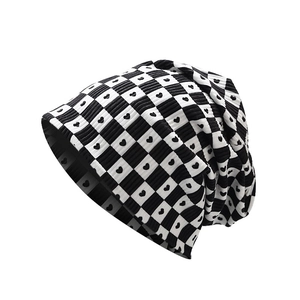 Classic black and white checkerboard knit beanie with heart pattern on white background