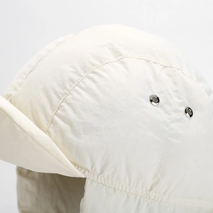 Detailed close-up of cream winter flight hat featuring windproof fabric and metal eyelets