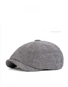 Close-up of dark gray cotton linen newsboy cap showing fine texture and panel stitching