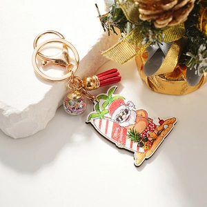 Christmas Santa surfing keychain with red tassel, gold clip and festive sequin ball charm