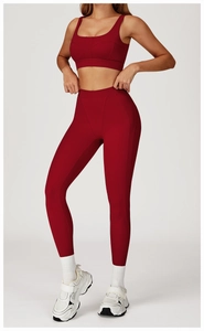 Detailed full-body shot of burgundy high-waisted yoga leggings and U-neck sports bra set