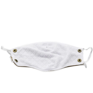Macro detail of white quilted ear warmer mask with brass buttons and elastic straps