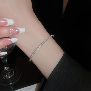 Close-up of elegant silver tennis bracelet with cubic zirconia worn on a female wrist
