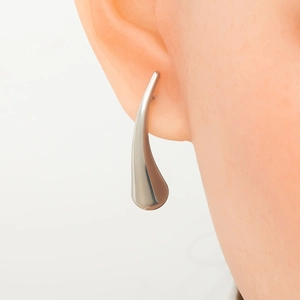 Detailed view of a silver-tone hollow spiral teardrop earring worn on the ear model