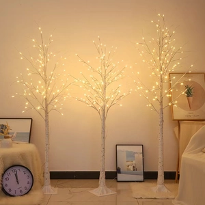 Three LED birch tree lights in different heights emitting warm yellow glow for home decor