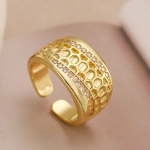 18K gold plated wide honeycomb ring with white zircon stones on a warm beige background