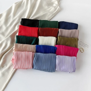 Close-up showing a variety of colorful pleated 70cm silk scarves in satin texture