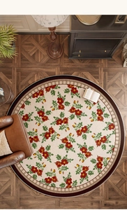 Detail of round floral rug in French vintage style with roses on wood floor
