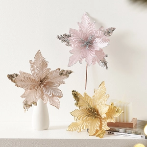 Glitter poinsettia Christmas flowers in pink, champagne, and gold for tree decoration