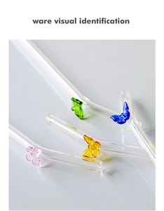 Detail of bent heat-resistant glass straws with colorful handmade 3D butterfly ornaments