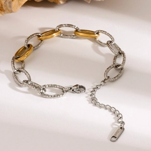 Detail of two-tone stainless steel bracelet with gold links and hammered silver beads