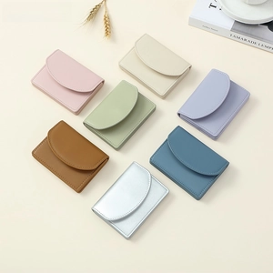 Close-up of minimalist leather mini wallets in multiple colors with stitch detail