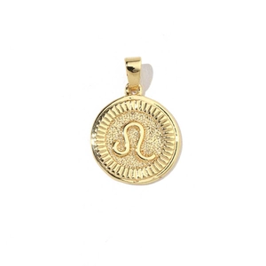 Detail of 18k gold plated Leo zodiac charm with embossed symbol and sunburst texture