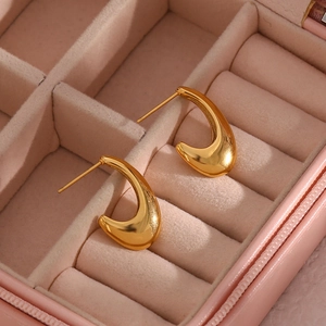 Minimalist gold teardrop hook earrings with polished finish in jewelry box