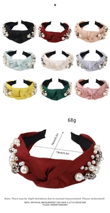 Detail view of knotted fabric headband with pearls showing 16cm height and 14cm width dimensions