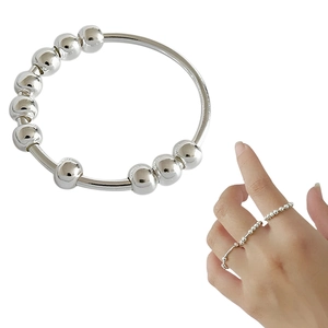 Macro view of a stainless steel anti-anxiety spinner ring featuring 10 rotatable beads
