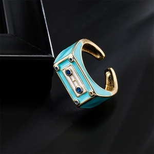 Punk style adjustable robot cassette ring with blue enamel and gold finish on silk