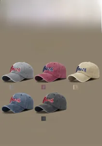 Flat lay of vintage washed baseball caps in five colors with Brush letter embroidery