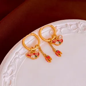 Matte gold butterfly flower enamel hoop earrings with a vintage Chinese style aesthetic