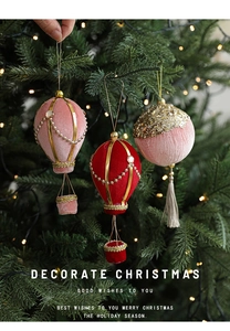 Detail of velvet hot air balloon Christmas ornaments with pearls and sequins on a tree