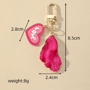 Detail view of pink heart LOVE pendant keychain with irregular resin stone and lobster clasp