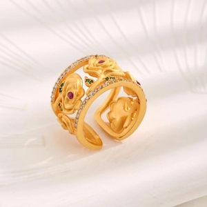 Detailed macro view of a vintage gold-plated open ring with hollowed rose and gems