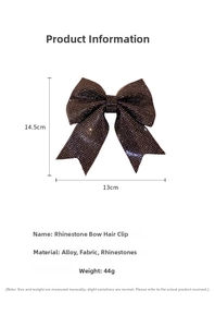 Detailed view of large black rhinestone bow hair clip with alloy spring clip mechanism