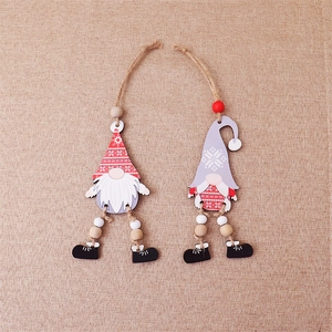 Detail of two wooden Christmas gnomes with dangling legs on a rustic burlap background