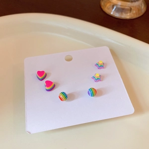 Detail view of colorful rainbow striped resin stud earring set with heart and star shapes