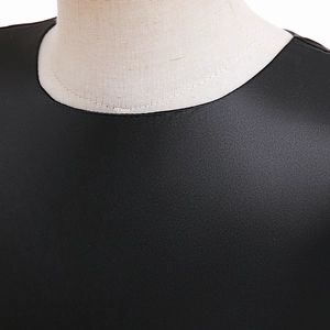 Detail shot of the black round neckline on a girls Halloween witch pumpkin dress