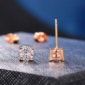 Macro detail of classic four-prong rose gold stud earrings with round cubic zirconia