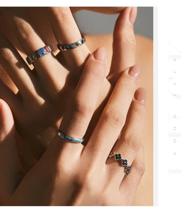 Artistic macro shot of s925 silver rings with turquoise heart and clover shaped gemstones