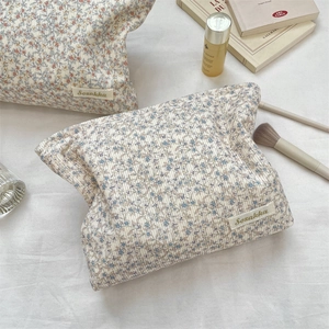 Detailed close-up of corduroy floral makeup bag with elegant blue and pink flower patterns