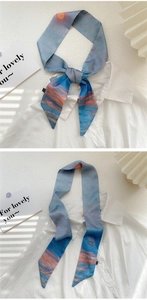 Flat lay of artistic oil painting style blue and orange silk scarf with decorative card