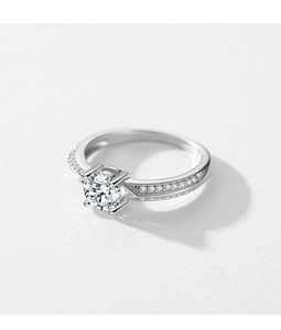 Macro view showing the round brilliant cut center diamond and side pave diamonds on silver band