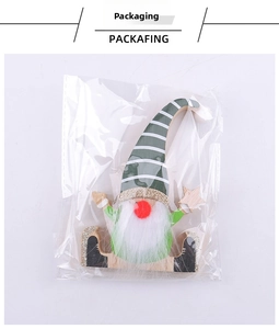 Christmas gnome wooden ornament with white beard and star in clear packaging