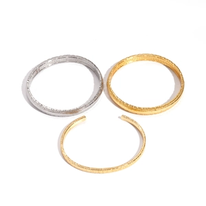 Minimalist 18k gold plated textured round metal bangles with industrial vintage design