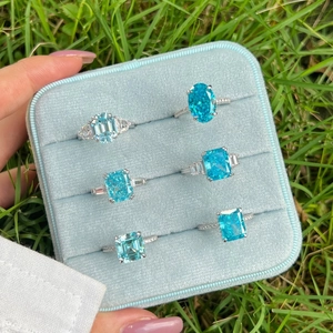 Set of S925 sterling silver rings with blue zircon stones in a light blue velvet box