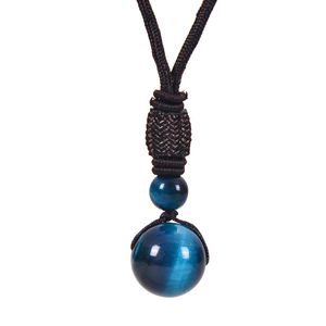 Detail of blue tiger eye stone pendant showing cat eye effect on black braided cord