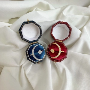 Macro view of S925 sterling silver star and moon rings in velvet jewelry gift boxes