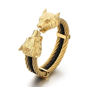Golden double wolf head open bangle featuring braided black leather and steel wire