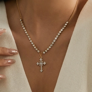 Elegant gold-plated cross necklace with white rhinestones on a delicate chain