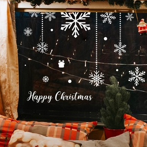 White Christmas snowflake window clings for festive home glass decoration in a cozy room