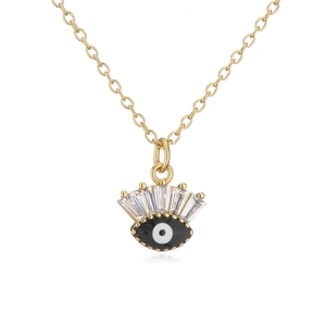 Detail of 18K gold plated evil eye pendant with black enamel and baguette zircons