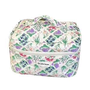 Quilted floral makeup bag with purple flower pattern and top handle for travel