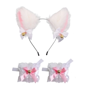 Detailed view of white cat ear headband and lace wristbands with pink bows and gold bells